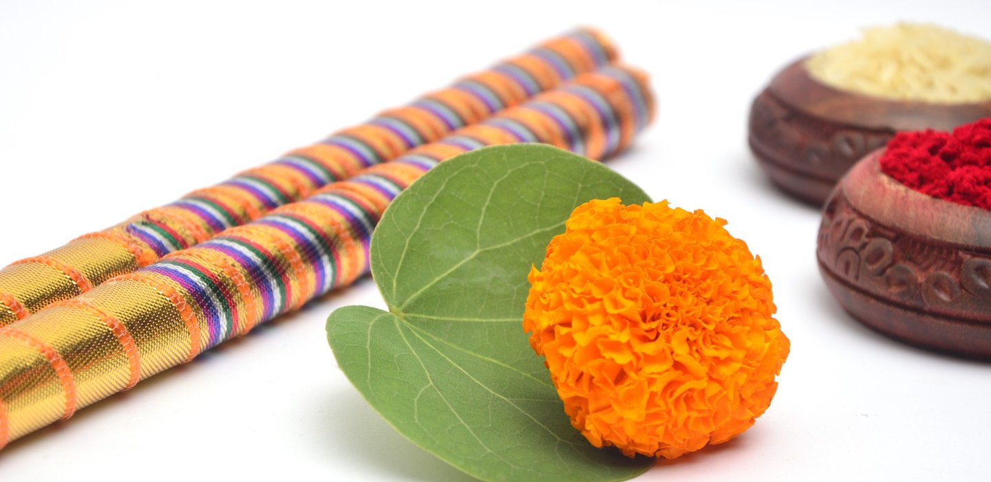 Dandiya sticks and festive marigold details