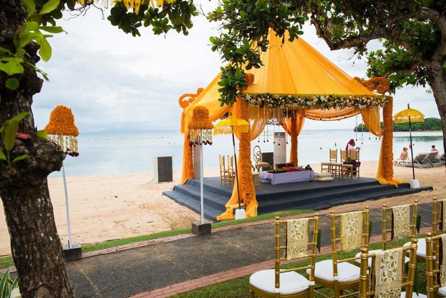Yellow floral mandap beside the sea